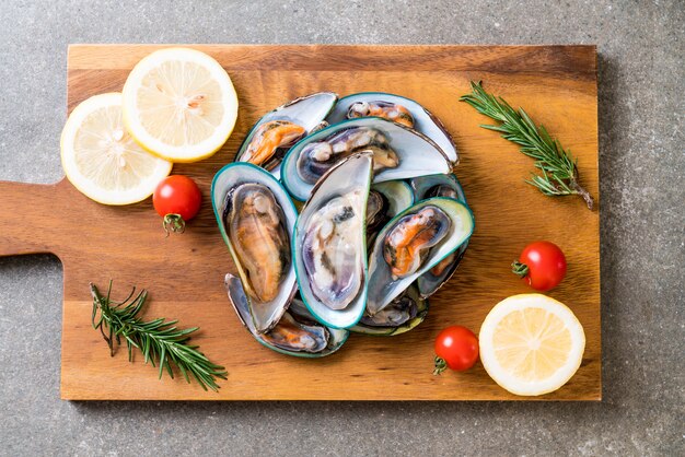 fresh mussels on wooden board