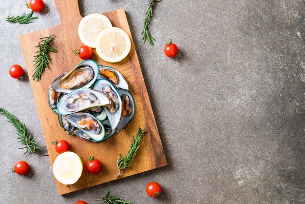 fresh mussels on wooden board