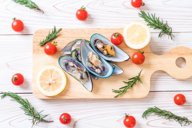 fresh mussels on wooden board