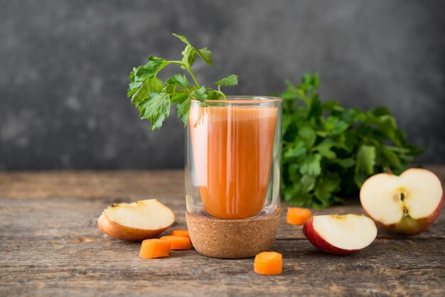 Fresh natural apple carrot juice in a glass glass  