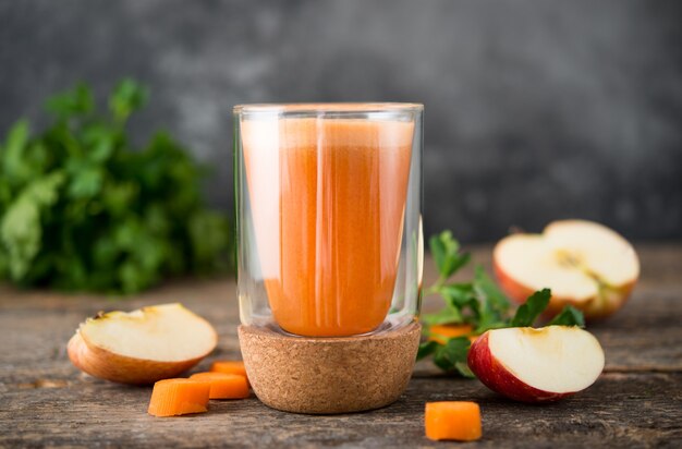 Fresh natural apple carrot juice in a glass glass