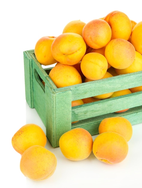 Fresh natural apricot in wooden box isolated on white