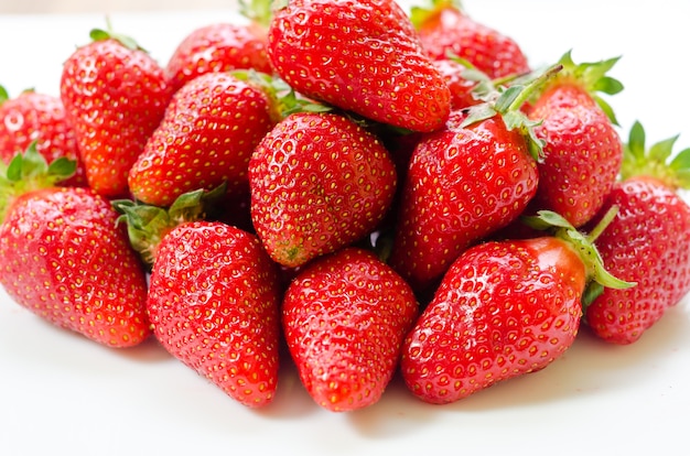 Fresh and natural garden strawberries on a white plat