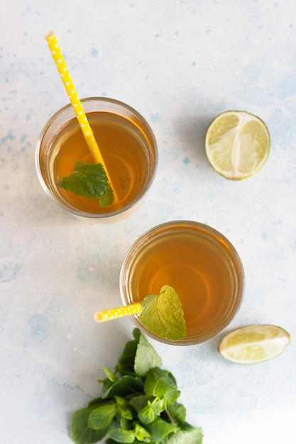 Fresh natural green peppermint herbal tea in glasses with fresh mint leaves and lime