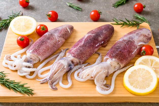 fresh octopus or squids raw on wooden board