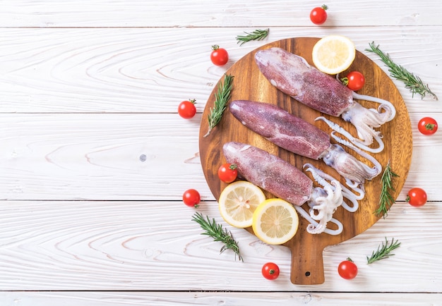 fresh octopus or squids raw on wooden board