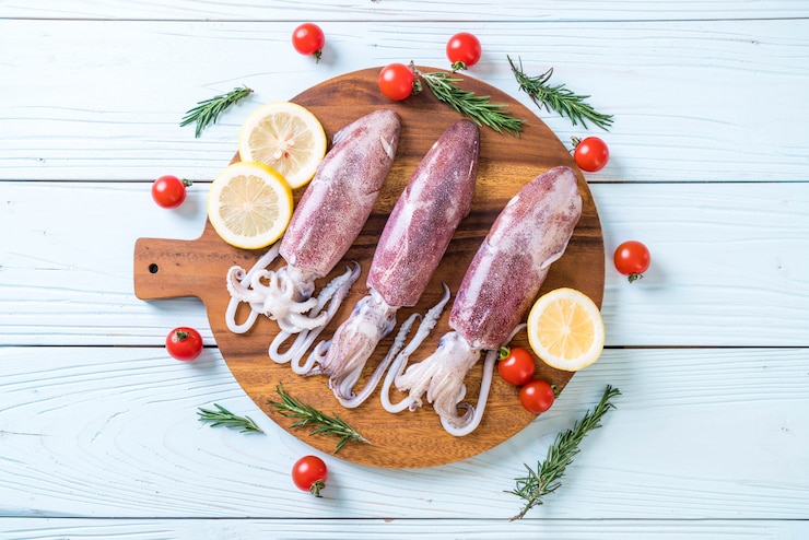 fresh octopus or squids raw on wooden board
