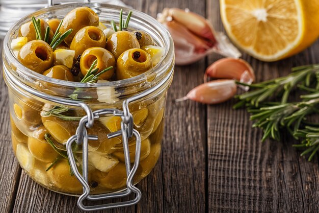 Fresh olives with rosemary, garlic, lemon.