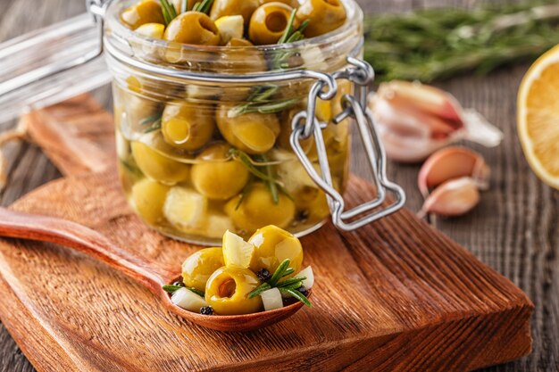 Fresh olives with rosemary, garlic, lemon.