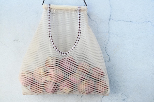 Fresh onion in a reusable shopping bag