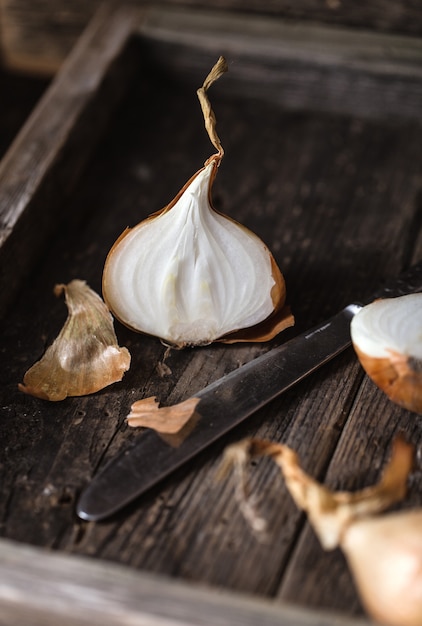 Fresh onions on rustic wooden table.