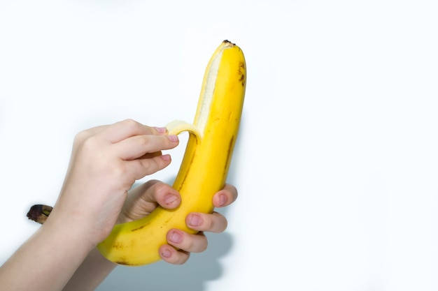 Fresh open yellow banana in hand isolated on white