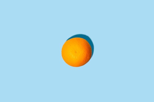 Fresh orange on a blue background Top view flat lay