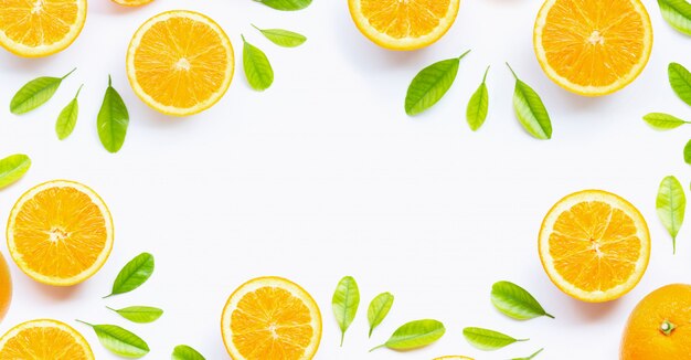 Fresh orange citrus fruit with leaves isolated on white background.