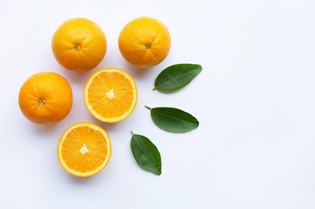 Fresh orange citrus fruit with leaves isolated on white wooden background. 