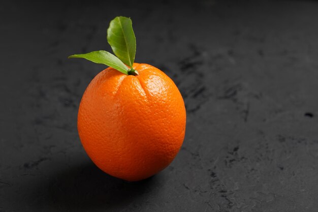 Fresh orange fruit on black background