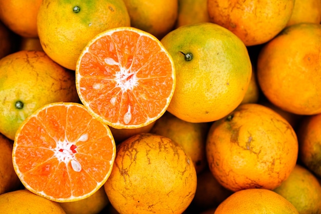 Photo fresh orange fruits with leaves as background