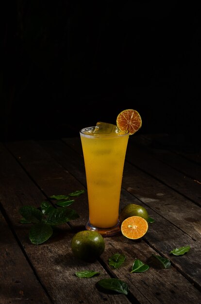 Fresh orange ice with orange slices on wooden table