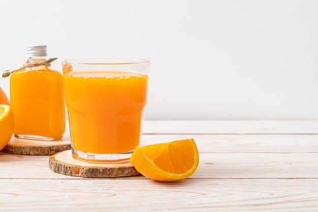 fresh orange juice glass on wood background