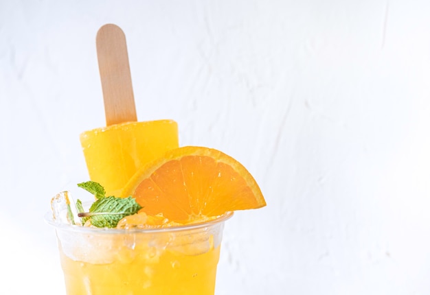 Fresh orange juice in glassescubes of ice and slice of fruits with icecream