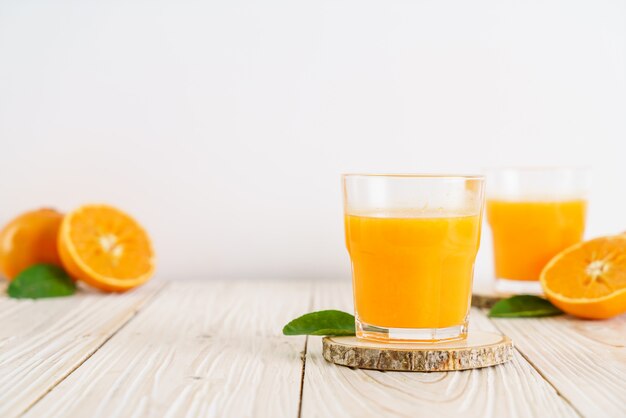 Fresh orange juice on wood background