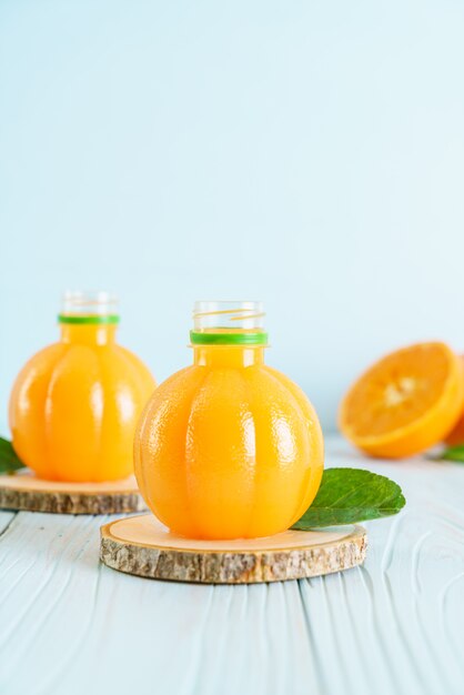 Fresh orange juice on wood background