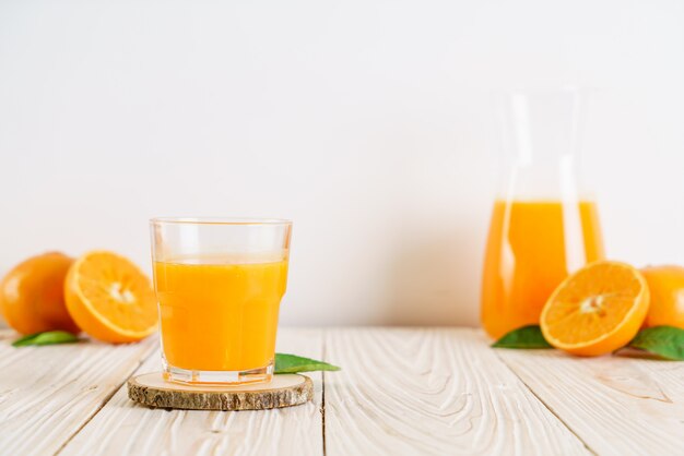 Fresh orange juice on wood background