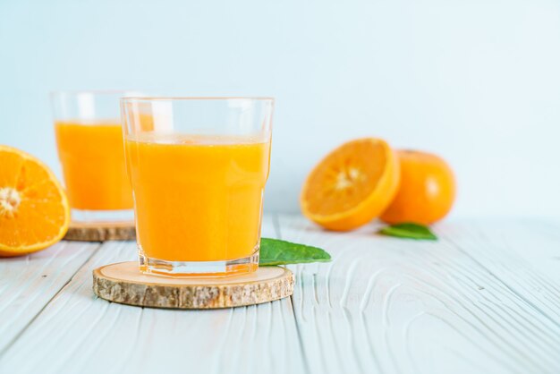 Fresh orange juice on wood background