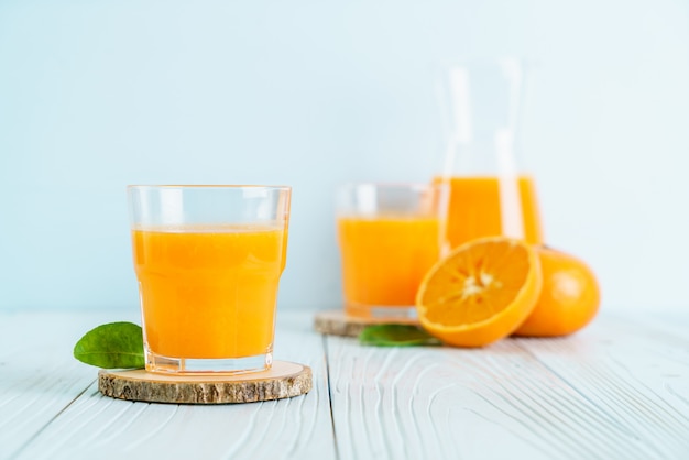 Fresh orange juice on wood background