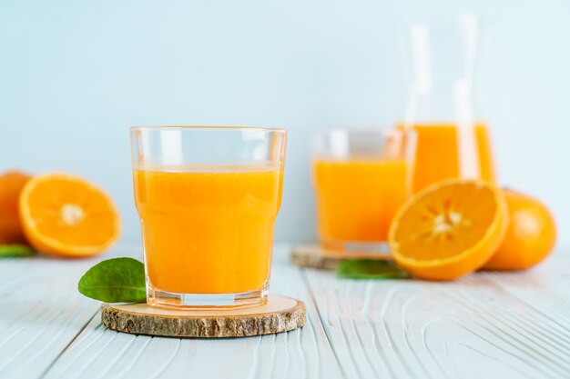 Fresh orange juice on wood background