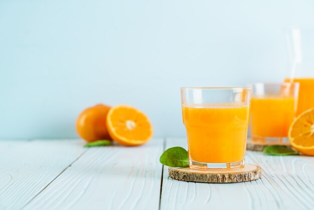 Fresh orange juice on wood background