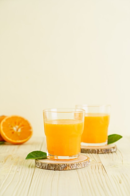 Fresh orange juice on wood background