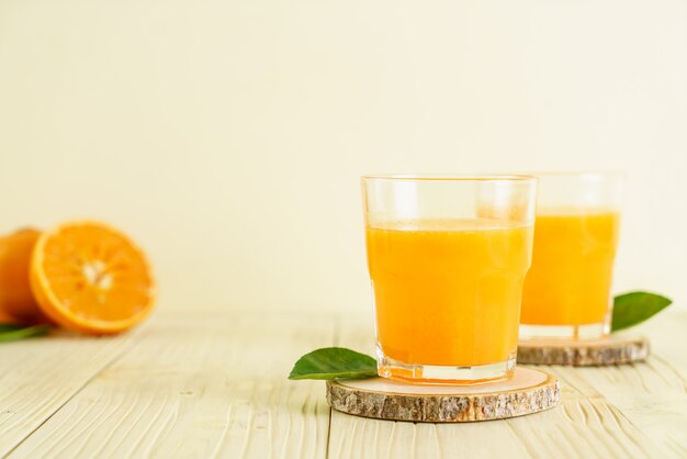 Fresh orange juice on wood background