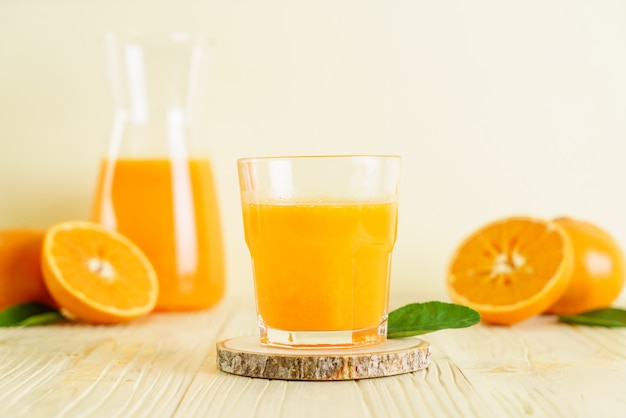 Fresh orange juice on wood background