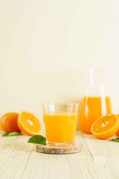 Fresh orange juice on wood background