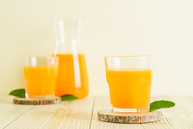 Fresh orange juice on wood background