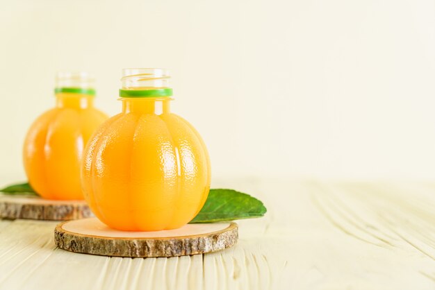 Fresh orange juice on wood background
