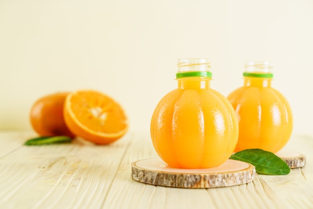 Fresh orange juice on wood background