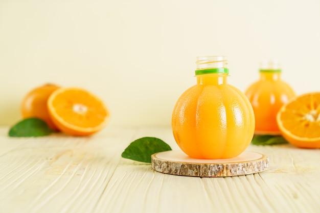 Fresh orange juice on wood background