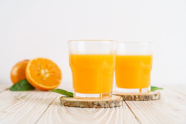 Fresh orange juice on wood background