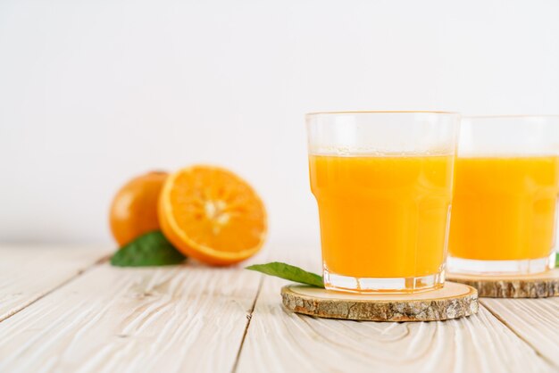 Fresh orange juice on wood background