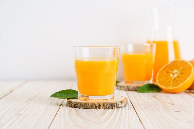 Fresh orange juice on wood background