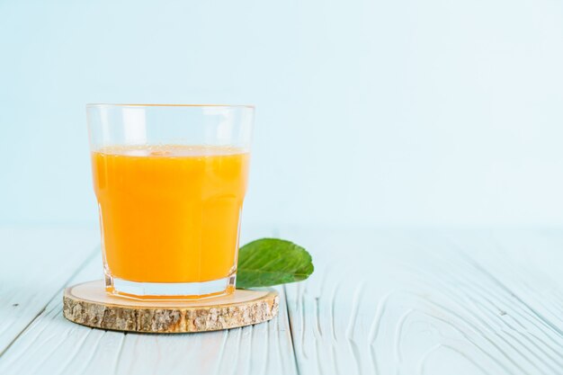 Fresh orange juice on wood surface