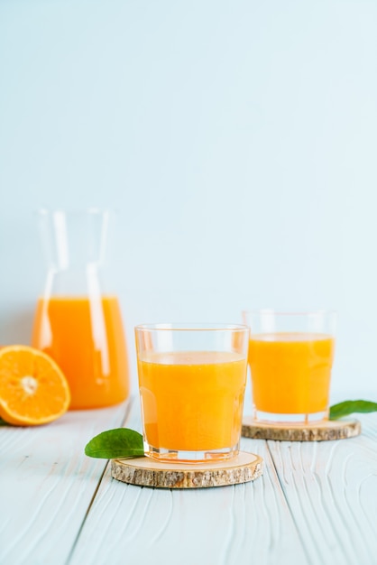 Fresh orange juice on wood surface