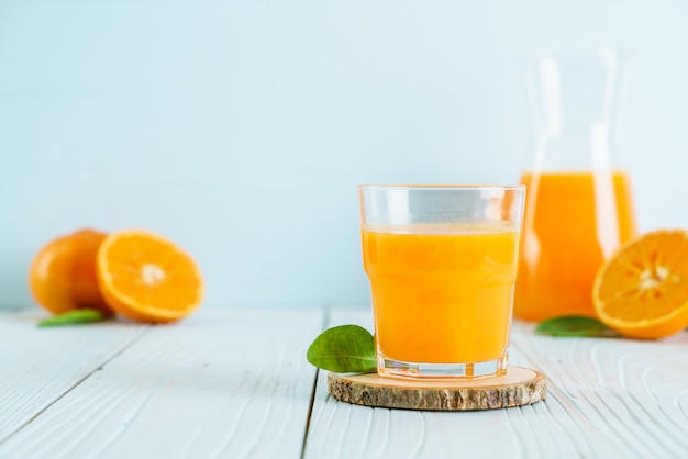 Fresh orange juice on wood surface