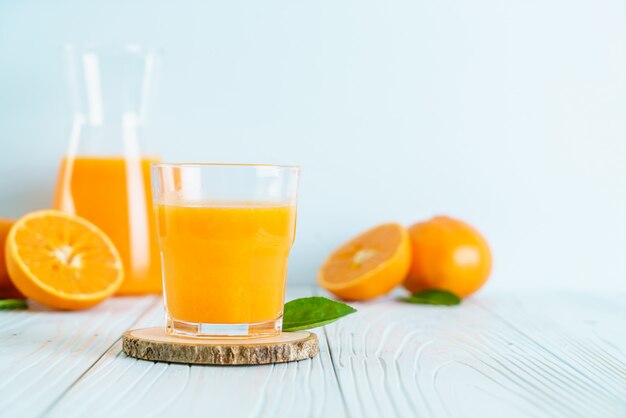 Fresh orange juice on wood surface