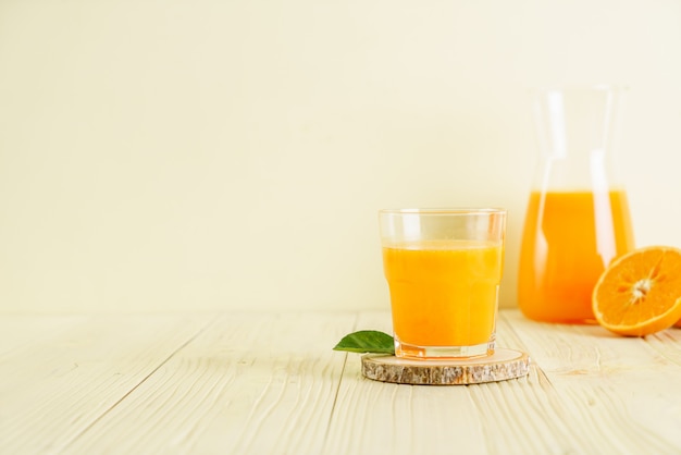 Свежевыжатый апельсиновый сок на поверхности дерева
