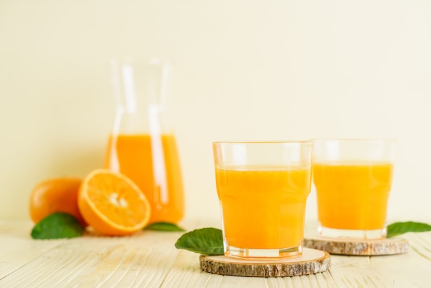 Fresh orange juice on wood surface