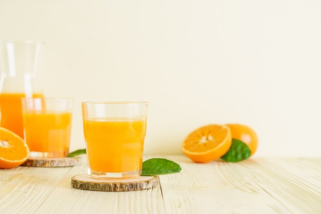 Fresh orange juice on wood surface