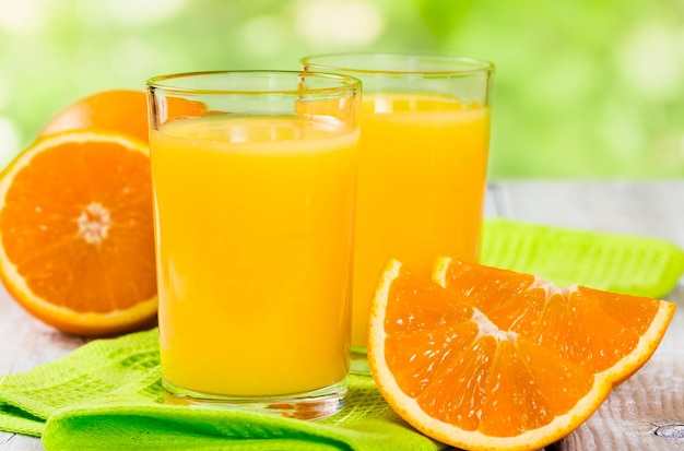 Fresh orange juice on a wooden background